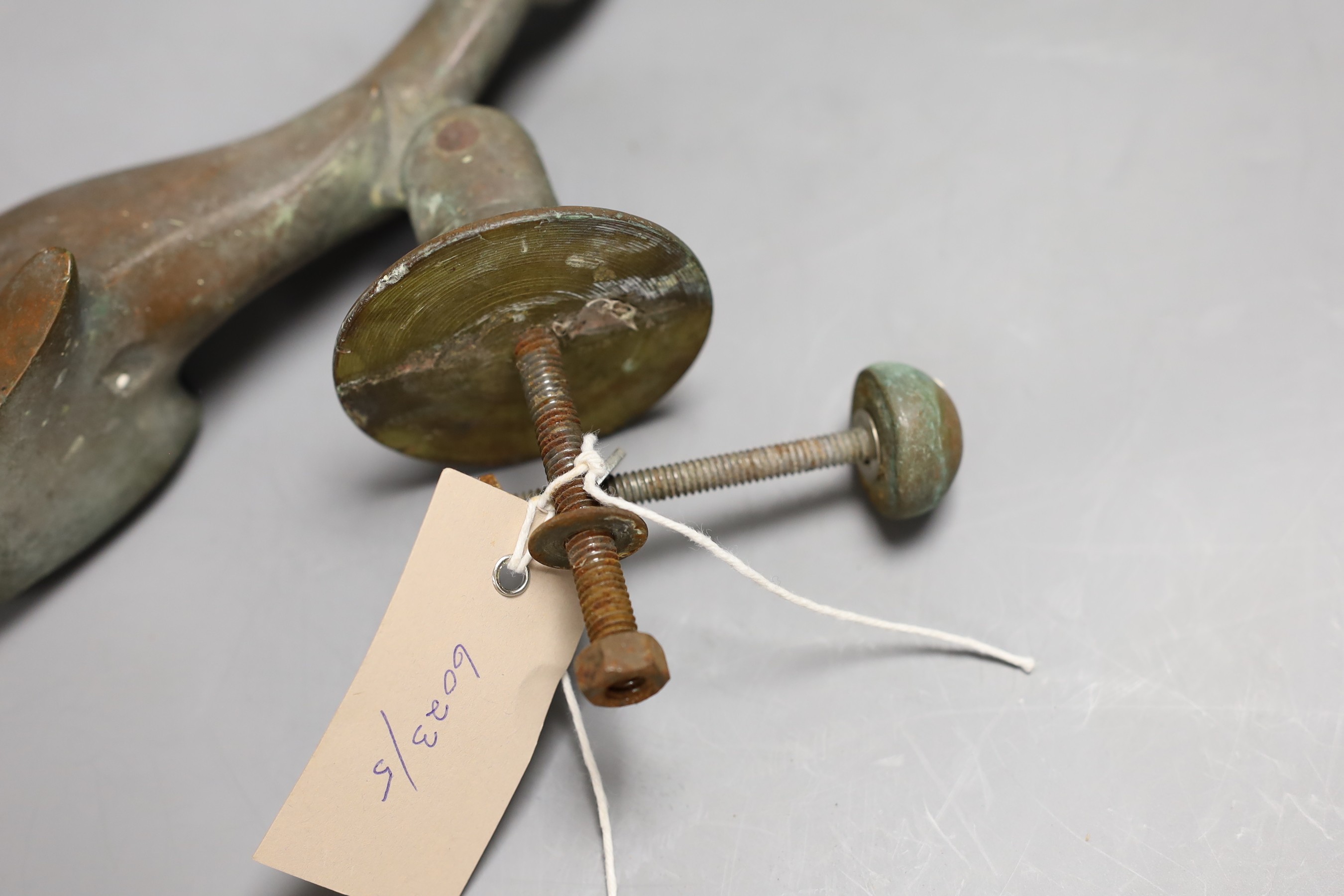 A Victorian cast bronze Dolphin door knocker, 21cms long.